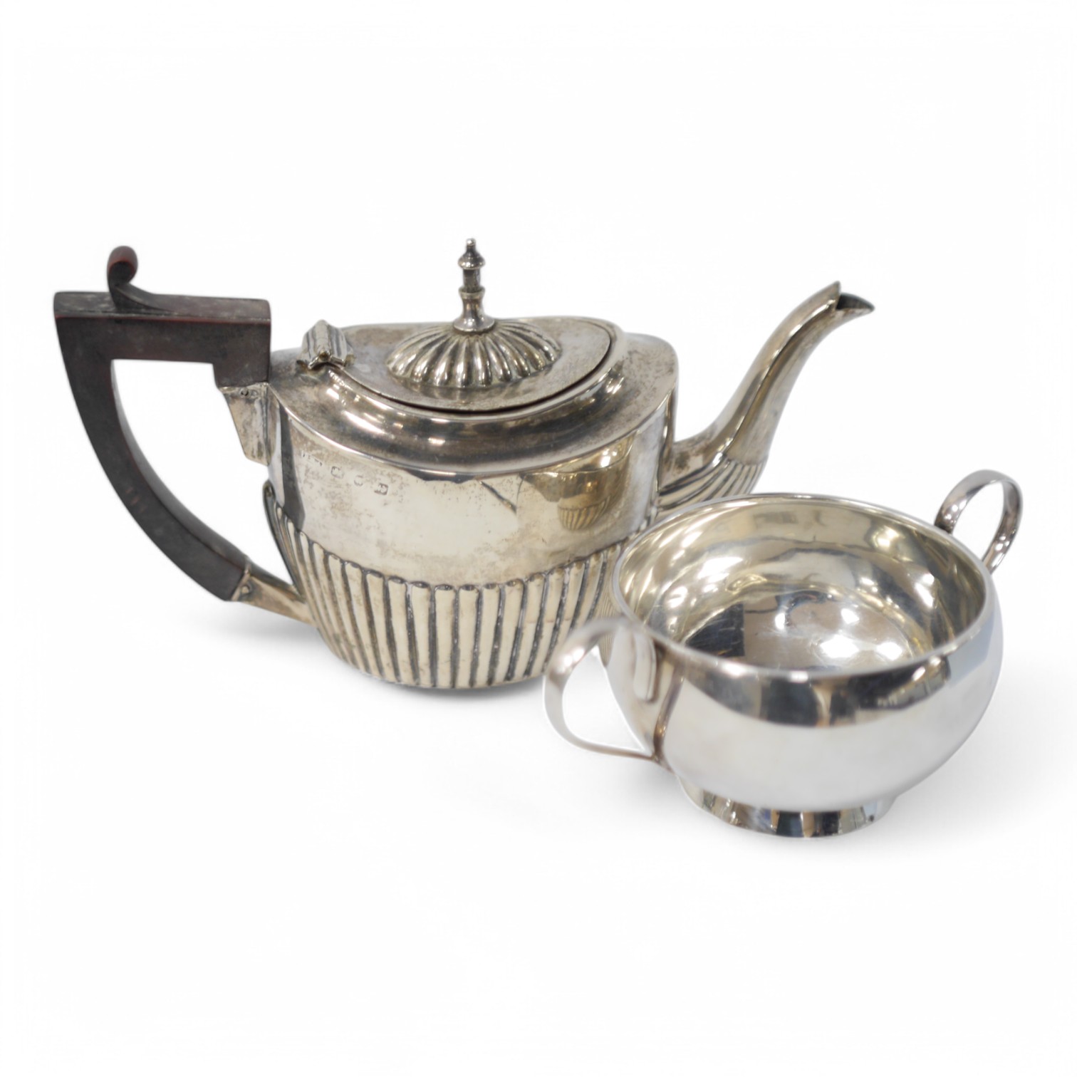 A late Victorian bachelor's demi-fluted silver teapot, Birmingham, 1894, together with a George V silver two handled bowl by Hukin & Heath, gross weight 11.3oz. Condition - fair